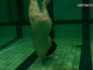 Brunette teen Kristina Andreeva swims naked in the pool underwater