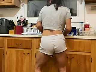 anna maria continues doing dishes while dancing in the kitchen