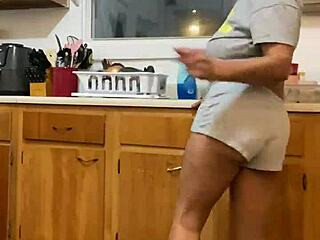anna maria continues doing dishes while dancing in the kitchen