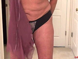 busty old woman strips bra off to flash naked body in homemade clip.