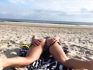Milf toys with stranger’s cock on public beach for fun