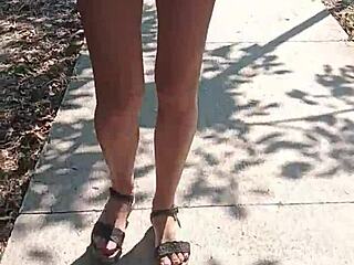 A woman walks naked on the street in public.