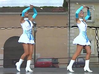Two nice majorettes perform cheerleading routine