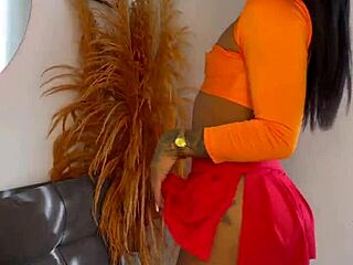 In this teasing scene, a crossdressing figure with a fat ass shakes it provocatively, highlighting the big cock in a transsexual encounter