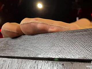 Beautiful feet of the mistress in flesh-colored tights tease you on the table close-up!